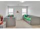 Bright bedroom with twin beds, a white dresser, and playful decorations at 5372 Fountain Head Ln, Auburn, GA 30011