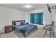 Well-lit bedroom with carpet, a mounted TV, and neutral decor at 5372 Fountain Head Ln, Auburn, GA 30011