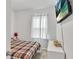 Cozy bedroom with a plaid bedspread and a mounted flatscreen TV at 5372 Fountain Head Ln, Auburn, GA 30011