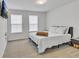Cozy bedroom with two windows and blinds, a wall-mounted TV, and carpeted floors at 5372 Fountain Head Ln, Auburn, GA 30011