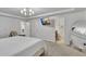 Bright bedroom with a tray ceiling, modern lighting, and ensuite bathroom access at 5372 Fountain Head Ln, Auburn, GA 30011