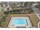 Aerial view of the community pool with plenty of lounge chairs and umbrella tables at 5372 Fountain Head Ln, Auburn, GA 30011