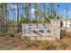 Stone community sign for Pinebrook at Hamilton Mill surrounded by landscaping and pine trees at 5372 Fountain Head Ln, Auburn, GA 30011