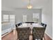Elegant dining area featuring a marble table, upholstered chairs, and hardwood floors at 5372 Fountain Head Ln, Auburn, GA 30011