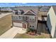 Charming two-story home with brick accents, dormers, landscaped front yard, and attached two-car garage at 5372 Fountain Head Ln, Auburn, GA 30011