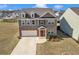 Two-story home showcasing a brick facade, attached garage, and manicured lawn at 5372 Fountain Head Ln, Auburn, GA 30011