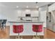 Stylish kitchen island featuring seating for two, a sink, and stainless steel appliances at 5372 Fountain Head Ln, Auburn, GA 30011