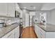 Bright kitchen with stainless steel appliances, granite countertops, and ample cabinet space at 5372 Fountain Head Ln, Auburn, GA 30011