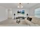 Bright living room featuring a modern chandelier and entertainment center at 5372 Fountain Head Ln, Auburn, GA 30011