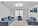 Relaxing living room area with comfy blue couches and a mounted TV at 5372 Fountain Head Ln, Auburn, GA 30011