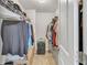 Organized walk-in closet with ample hanging and storage space at 5372 Fountain Head Ln, Auburn, GA 30011