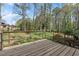 Inviting wooden back deck offering views of the lush, landscaped backyard and mature trees at 587 Coast Oak Cir, Lawrenceville, GA 30046