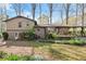 View of the backyard showcasing mature trees, a patio, and lush landscaping, creating a tranquil outdoor retreat at 587 Coast Oak Cir, Lawrenceville, GA 30046