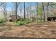 Lush backyard with mature trees, showcasing the home's exterior and providing a sense of privacy at 587 Coast Oak Cir, Lawrenceville, GA 30046