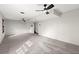 Large carpeted basement area, featuring two ceiling fans and a partially obscured doorway for flexible use at 587 Coast Oak Cir, Lawrenceville, GA 30046