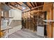 Unfinished basement with open framework and wooden shelves, offering potential for customization and storage at 587 Coast Oak Cir, Lawrenceville, GA 30046