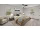 Serene bedroom with area rug, an armchair, plush carpeting, a ceiling fan, and two large windows at 587 Coast Oak Cir, Lawrenceville, GA 30046