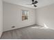 This bedroom features neutral walls and gray carpeting, along with a ceiling fan for added comfort at 587 Coast Oak Cir, Lawrenceville, GA 30046