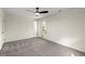 This bedroom features neutral walls and gray carpeting, along with a ceiling fan for added comfort at 587 Coast Oak Cir, Lawrenceville, GA 30046