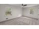 Spacious bedroom with plush carpeting, ceiling fan, and two large windows providing ample natural light at 587 Coast Oak Cir, Lawrenceville, GA 30046