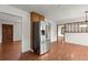 Stainless steel refrigerator stands out against a dining room with hardwood floors and paneled walls at 587 Coast Oak Cir, Lawrenceville, GA 30046