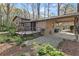 View of the home exterior with a patio, carport, and beautifully landscaped surroundings at 587 Coast Oak Cir, Lawrenceville, GA 30046