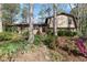 Inviting home with a brick facade, complemented by lush landscaping and colorful flowerbeds at 587 Coast Oak Cir, Lawrenceville, GA 30046