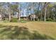 Charming two-story home with a spacious front yard and mature trees, creating a serene setting at 587 Coast Oak Cir, Lawrenceville, GA 30046