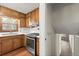 This kitchen features wooden cabinets and stainless steel appliances, along with a wooden floor at 587 Coast Oak Cir, Lawrenceville, GA 30046