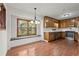 Bright kitchen with wood cabinets, stainless steel appliances, and hardwood flooring with seat under the window at 587 Coast Oak Cir, Lawrenceville, GA 30046
