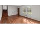 Hardwood floors and staircase create a warm and inviting entry area, emphasizing the natural light at 587 Coast Oak Cir, Lawrenceville, GA 30046