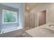 Modern bathroom featuring a soaking tub and a glass-enclosed shower at 1097 Bodega Loop, Locust Grove, GA 30248
