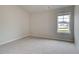Neutral bedroom featuring plush carpet, neutral walls, and a window with natural light at 1097 Bodega Loop, Locust Grove, GA 30248