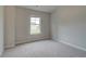 Neutral bedroom featuring plush carpet, neutral walls, and a window with natural light at 1097 Bodega Loop, Locust Grove, GA 30248