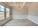 Bright dining room featuring a decorative ceiling, large windows, and stylish gray vinyl flooring at 1097 Bodega Loop, Locust Grove, GA 30248