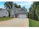 Two-story home featuring gray siding, white trim, an attached two-car garage, and a concrete driveway at 1097 Bodega Loop, Locust Grove, GA 30248