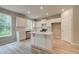 Bright kitchen with a central island, white cabinets, and stainless steel appliances at 1097 Bodega Loop, Locust Grove, GA 30248
