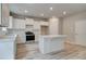 The kitchen features a functional island, white cabinets, and modern appliances at 1097 Bodega Loop, Locust Grove, GA 30248