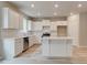 Stylish kitchen with white cabinets, island, stainless steel appliances, and modern fixtures at 1097 Bodega Loop, Locust Grove, GA 30248