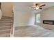 Open living room featuring a modern fireplace, natural light, and durable gray vinyl flooring at 1097 Bodega Loop, Locust Grove, GA 30248