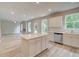 Open concept living area features kitchen island, stainless appliances, and modern fixtures at 1097 Bodega Loop, Locust Grove, GA 30248