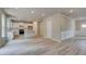 Open-concept living area features sleek floors and adjoins a kitchen with white cabinetry at 1097 Bodega Loop, Locust Grove, GA 30248