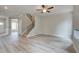 The living room features modern gray walls, a staircase, and sleek floors at 1097 Bodega Loop, Locust Grove, GA 30248