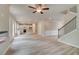 Open-concept living space with a kitchen and staircase, enhanced by stylish, wood-look vinyl floors at 1097 Bodega Loop, Locust Grove, GA 30248