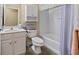 Bright and clean bathroom featuring a white vanity, toilet, and shower-tub combination at 126 Cottage Club Dr, Locust Grove, GA 30248