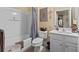 Inviting bathroom with a white vanity, toilet, and shower-tub combo with a stylish shower curtain at 126 Cottage Club Dr, Locust Grove, GA 30248