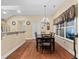 Cozy dining area with elegant chandelier, hardwood floors and view to kitchen at 126 Cottage Club Dr, Locust Grove, GA 30248