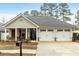 Inviting one-story home with a two-car garage and charming front porch, creating a welcoming curb appeal at 126 Cottage Club Dr, Locust Grove, GA 30248