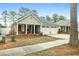 Charming single-story home featuring a two-car garage and inviting front porch, offering comfortable living at 126 Cottage Club Dr, Locust Grove, GA 30248