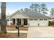 Charming single story home boasts a well-manicured lawn and attached two car garage at 126 Cottage Club Dr, Locust Grove, GA 30248